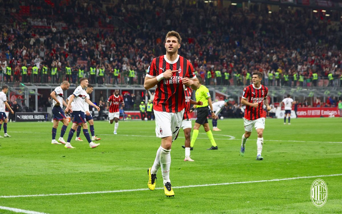 AC Milan players celebrate a crucial win against Bologna