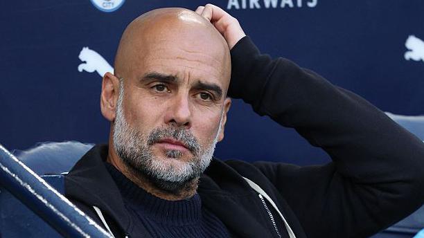 Pep Guardiola coaching Manchester City during a Premier League match
