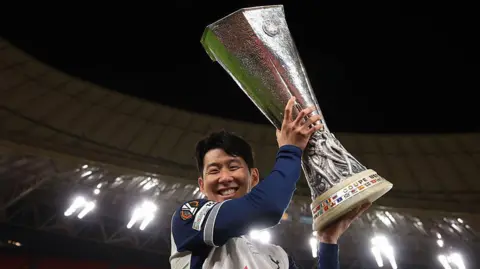 Son Heung Min lifts the Europa League trophy for Tottenham