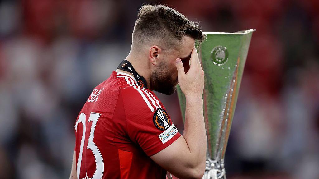 Manchester United players leave the pitch after the Europa League final defeat